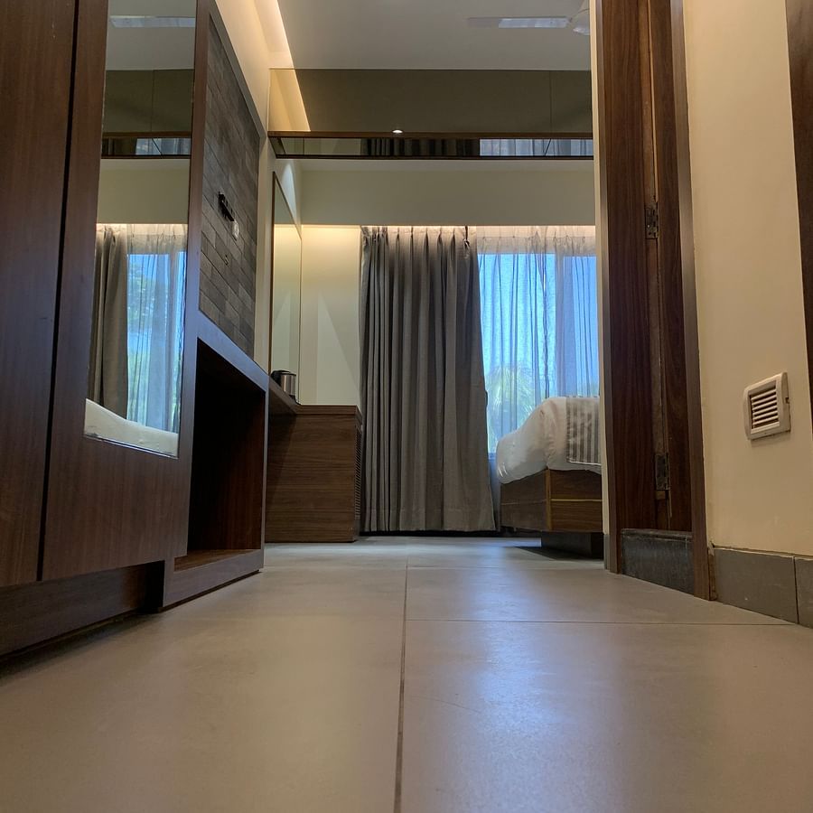 the walk through from the entrance to the bedroom of the stable facing room in Khandala - Zara's Resort 1