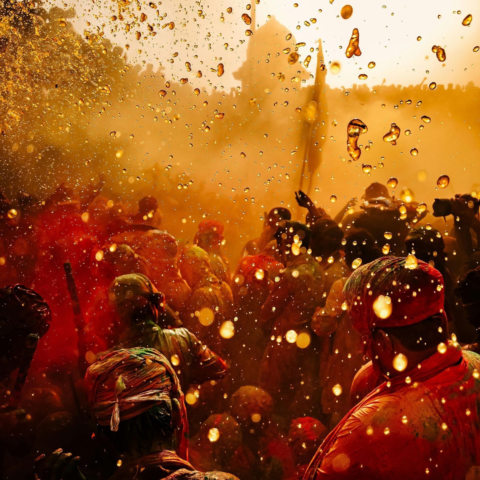 An image of people throwing holi colours at each other.