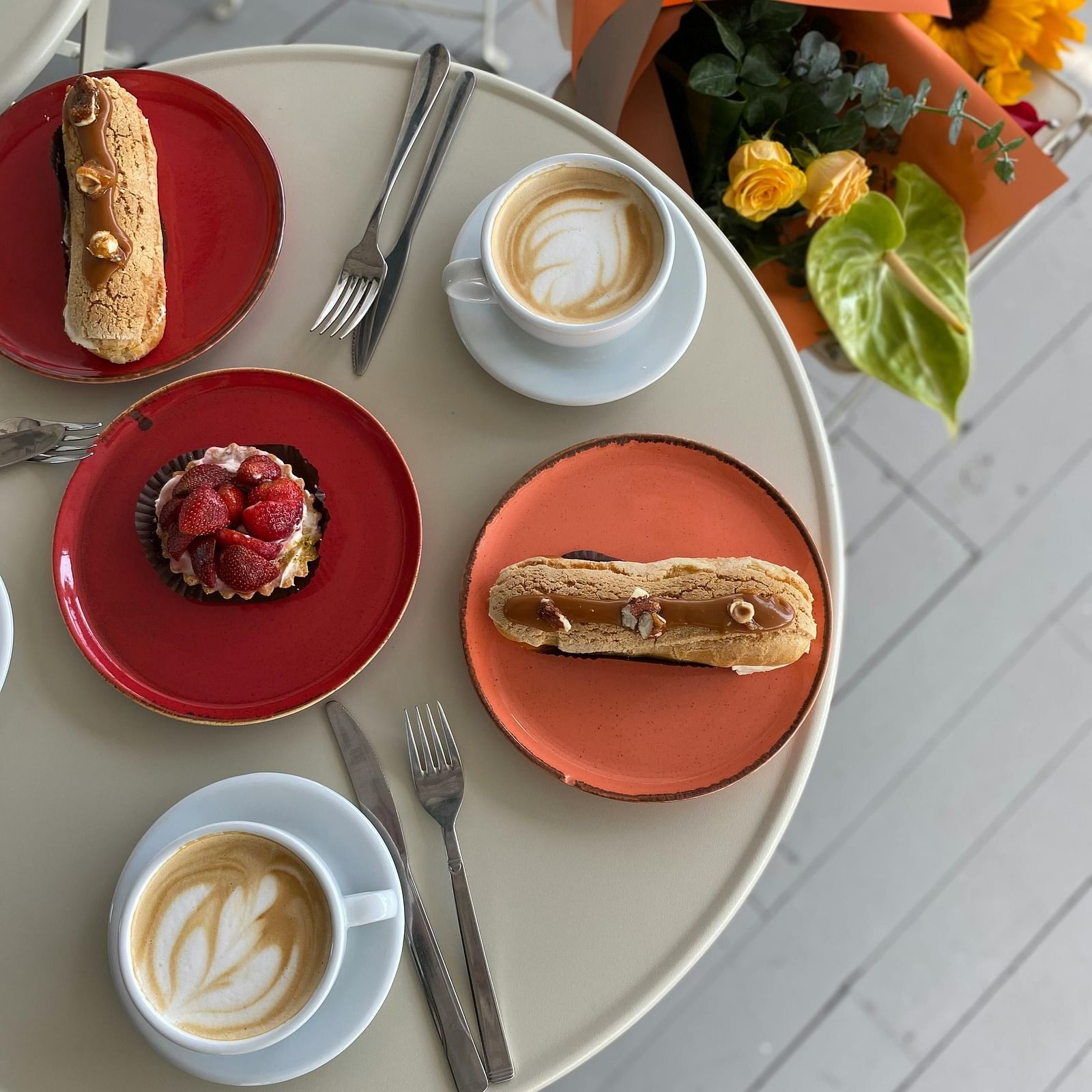 Brown Bread on Orange Plate beside Coffee on White Cup and Saucer