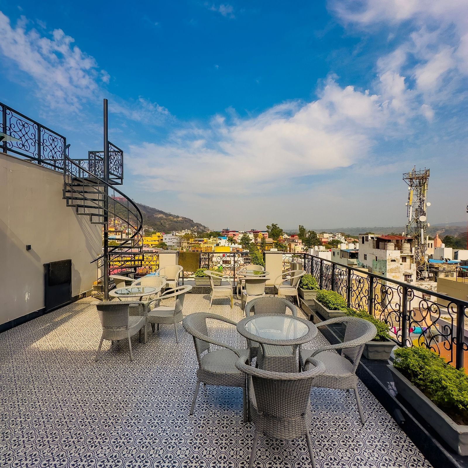 A roof top restaurant with a scenic view of a bright blue sky - Wonder Hills