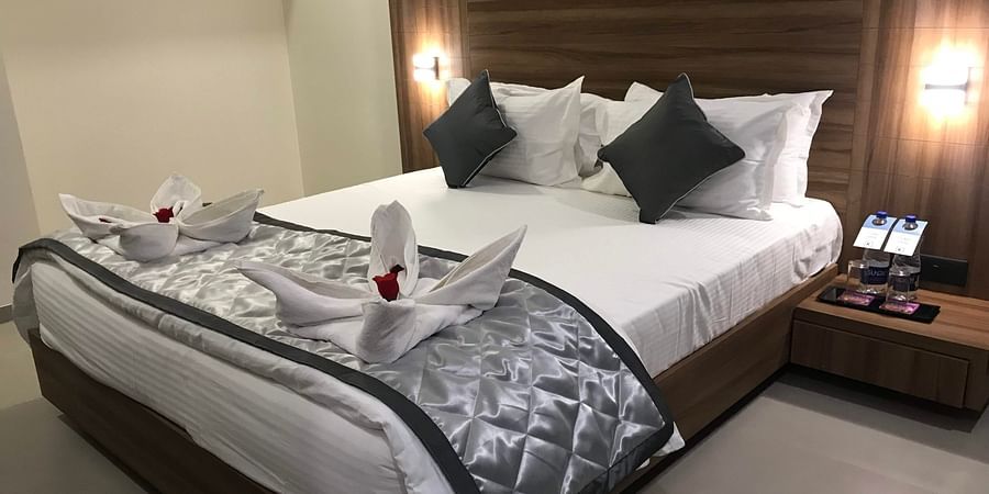 A shot of well-made bed in the Suite | Kyriad Hotel, Solapur