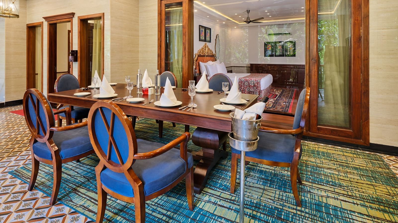 Royal Villa dining area with a table and six chairs surrounding it. It also leads to another room  through sliding glass doors.