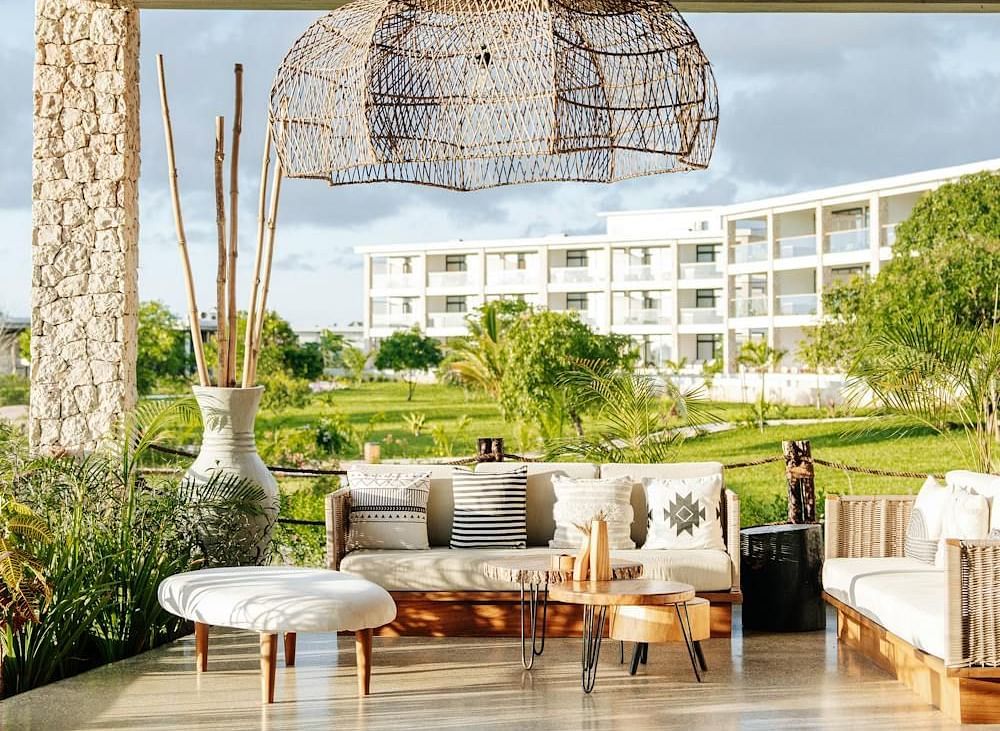 Image of an outdoor seating with sofas with tables in front