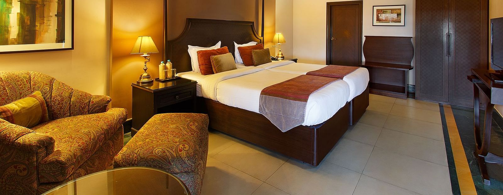 Comfortable double bed room with a sofa at Ganga Lahari Haridwar.
