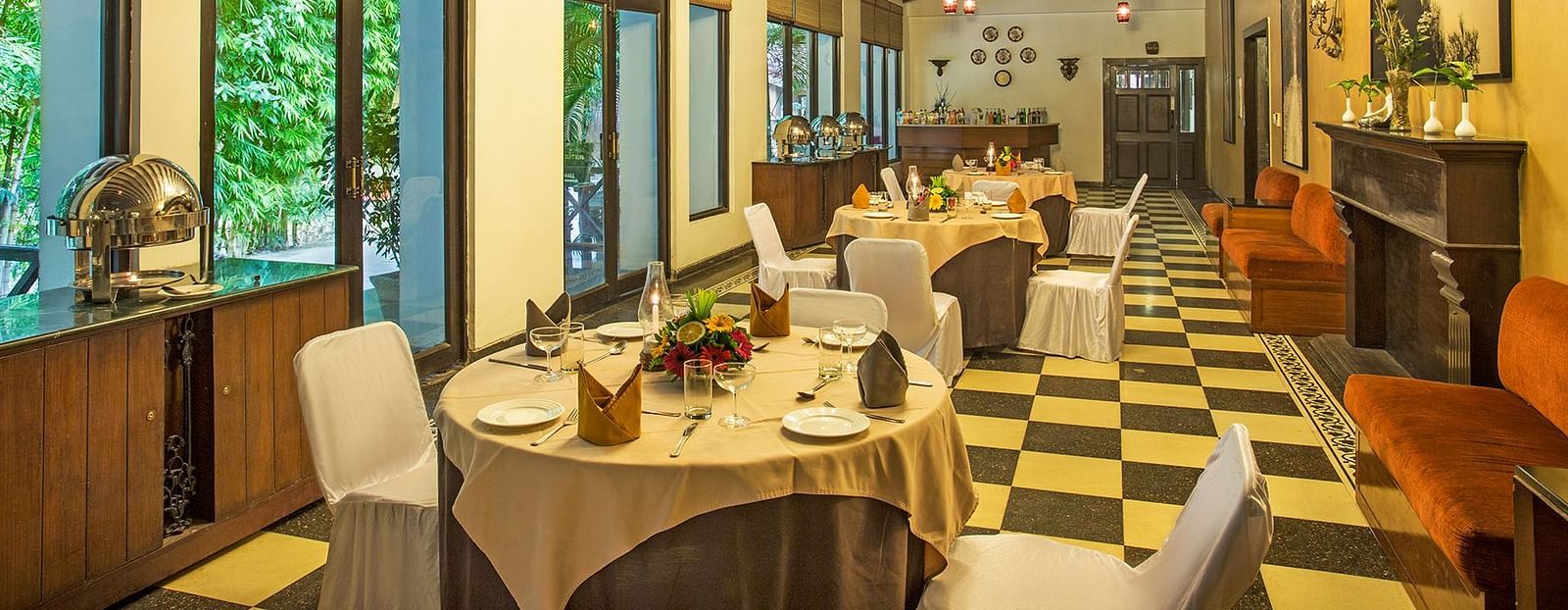 An image of a dining area with many table and chairs and a huge chandelier hanging from the ceiling- The Riverview Retreat, Corbett