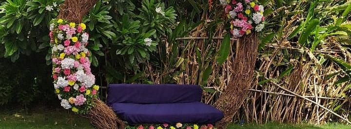 Circular floral swing, fabric, green grass, close up.