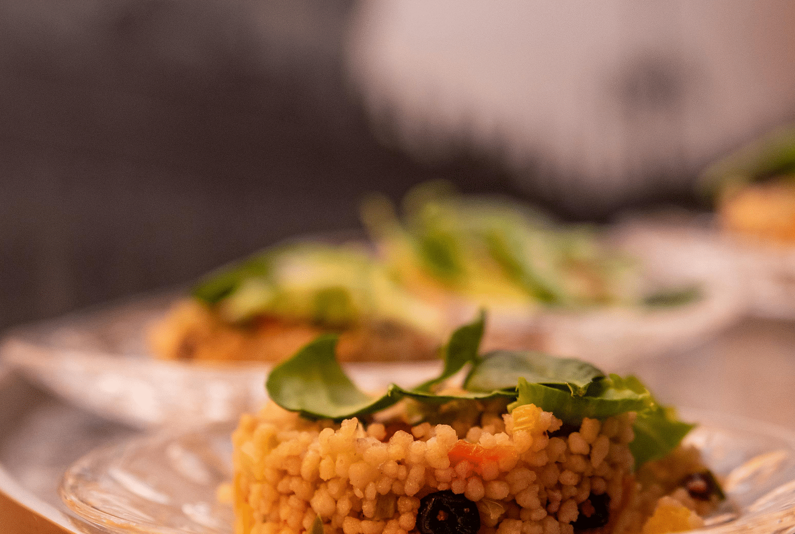 image of a dish made of rice served on a white china plate garnished with green veggies and herbs