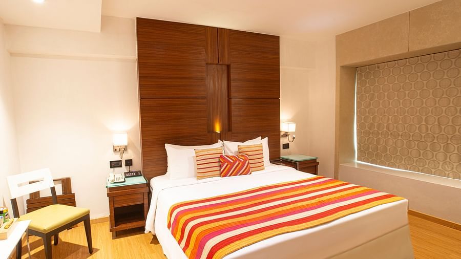 A side angle view Executive room with plushy bed.