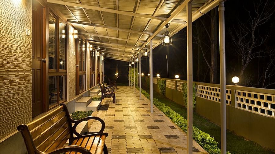 Abad Copper Castle covered walkway at night, illuminated by soft lighting.