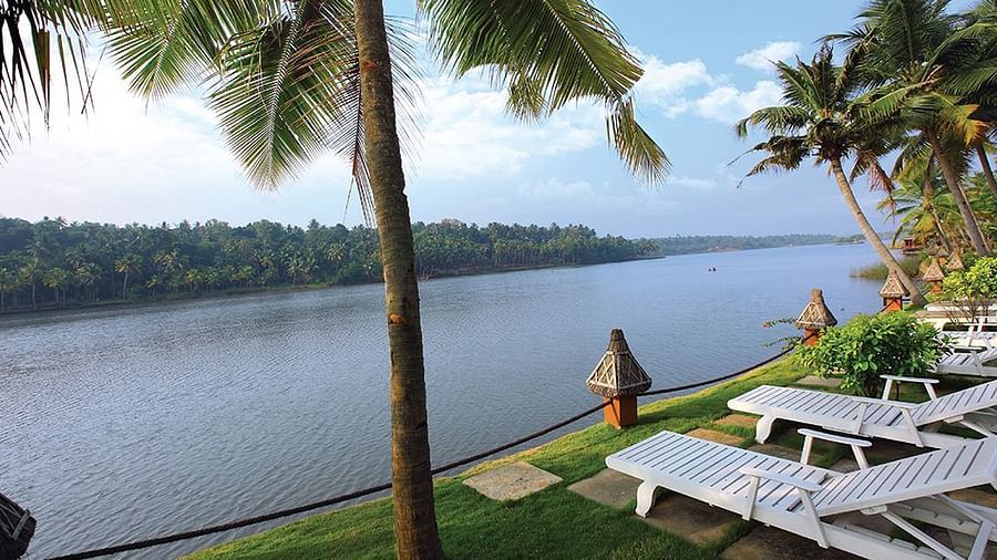 Lake view with boats on the shore and coconut trees framing the scene