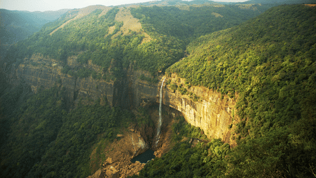 view of a hill with a waterfall cascading down 9