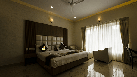 Suite featuring a king size bed, a chair, and sheer curtains. - Sukhi - A Luxury Stay Inn, Chikkamagaluru