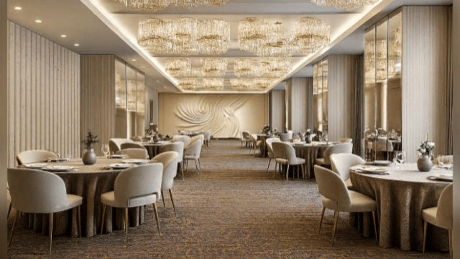 A formal dining room with round tables, cushioned chairs, and rectangular chandeliers
