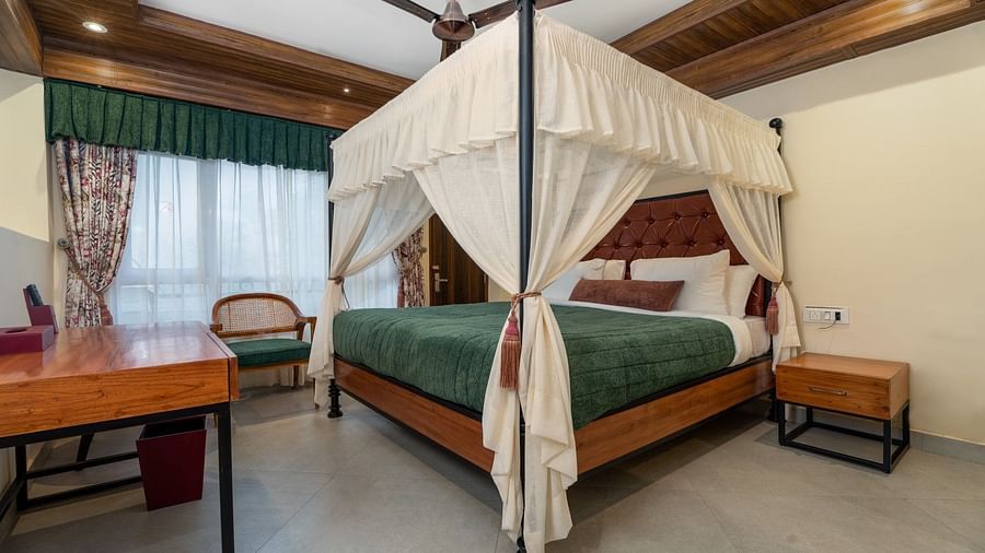A large bed with good lighting, plus wooden furniture