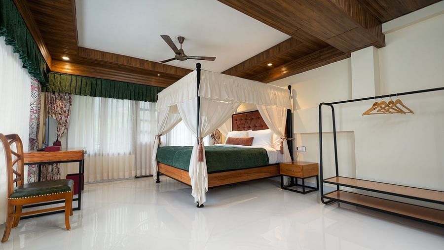  The Premium Suite with a Balcony boasts large windows, a spacious bed with ample lighting, and wooden furniture