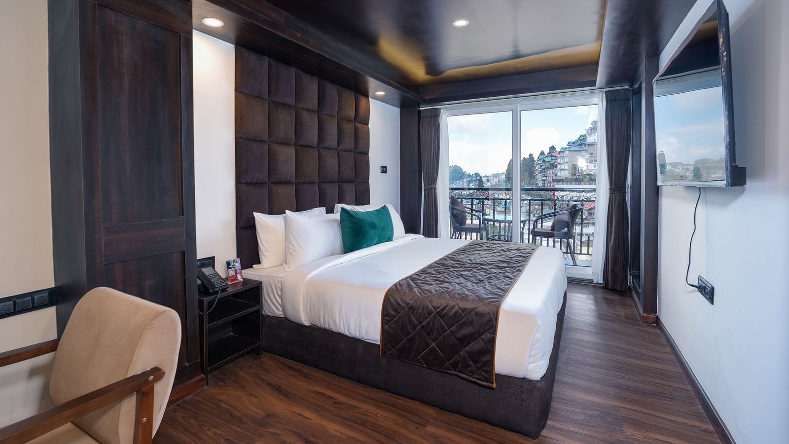 Image of a room that is well furnished with a king size bed and also has an access to a private balcony