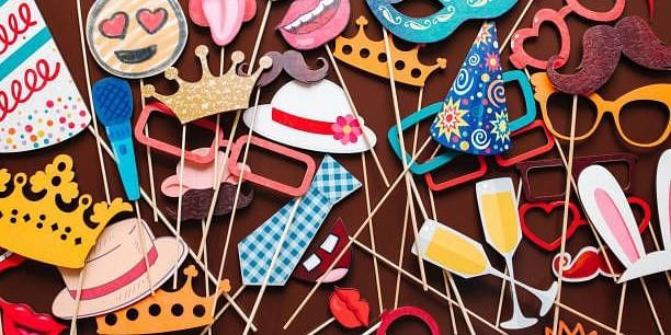 Colourful collection of fun photo booth props for wedding celebrations or parties.