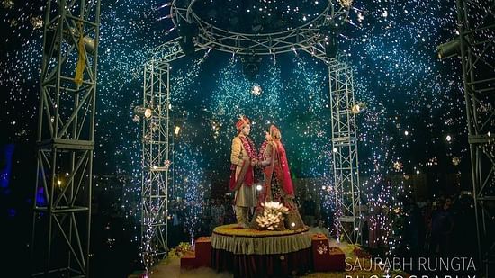 a bride and groom posing for a picture on a stage - Wedlock Greens Hotel Resorts Dhanbad