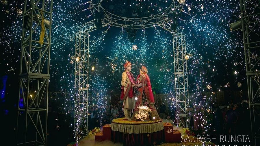 a bride and groom posing for a picture on a stage - Wedlock Greens Hotel Resorts Dhanbad