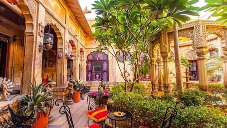 A lawn at Hotel Nachana Haveli with comfortable seating arrangement