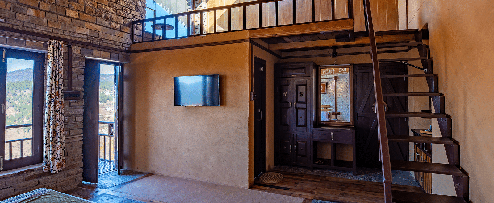 Spacious rustic room featuring a loft, wooden beams, and natural light streaming through windows. - Blusalzz Homes The Himalayan Bungalow, Almora