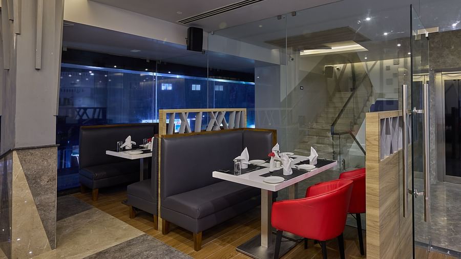 Booth seating in the restaurant at Grand Continent - A Sarovar Premiere Affiliate Hotel, Hosur