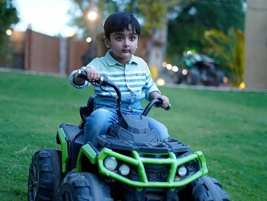 A child riding electric car at Themis Mudhouse - A Nature's Retreat Resort & Wellness