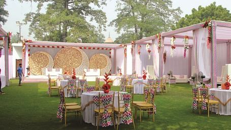Outdoor wedding setup with round tables and floral decor | Gemini Continental