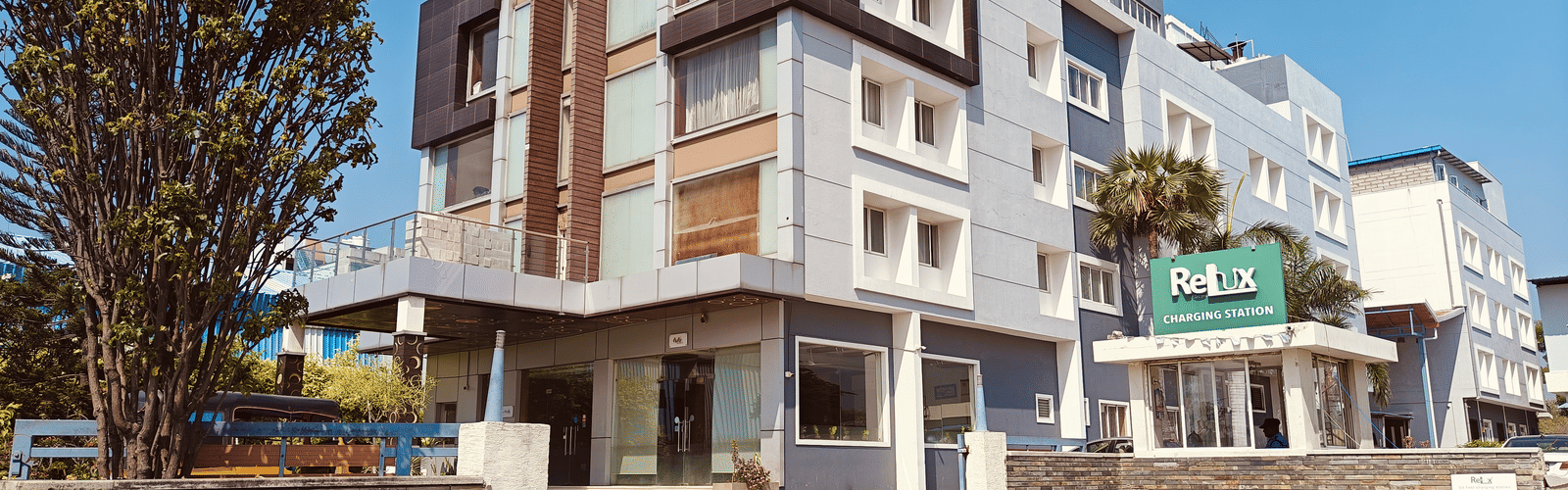 Exterior view of Alps Residency, Krishnagiri, with modern architecture and a spacious entrance.