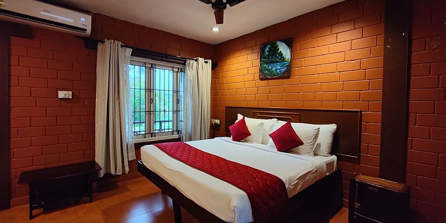 a double bed inside Executive Deluxe Room View at Ibex River Resort, Pollachi