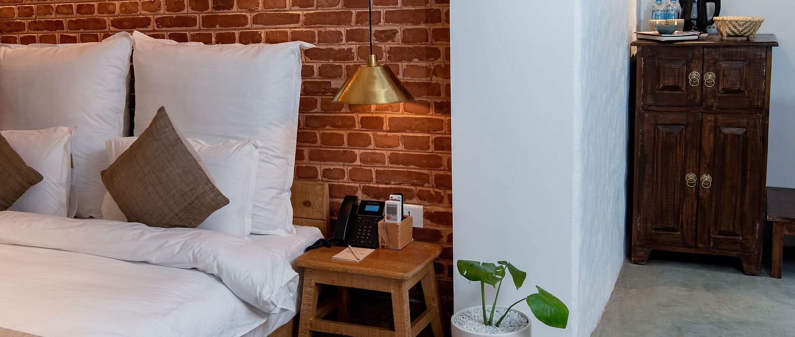 The Nepali Suite featuring a bed with pillows and cushions - The Nanee