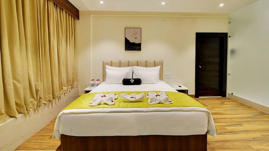 An image of a king size bed in a Suite at Mastiff Select Hotel Gulbarga