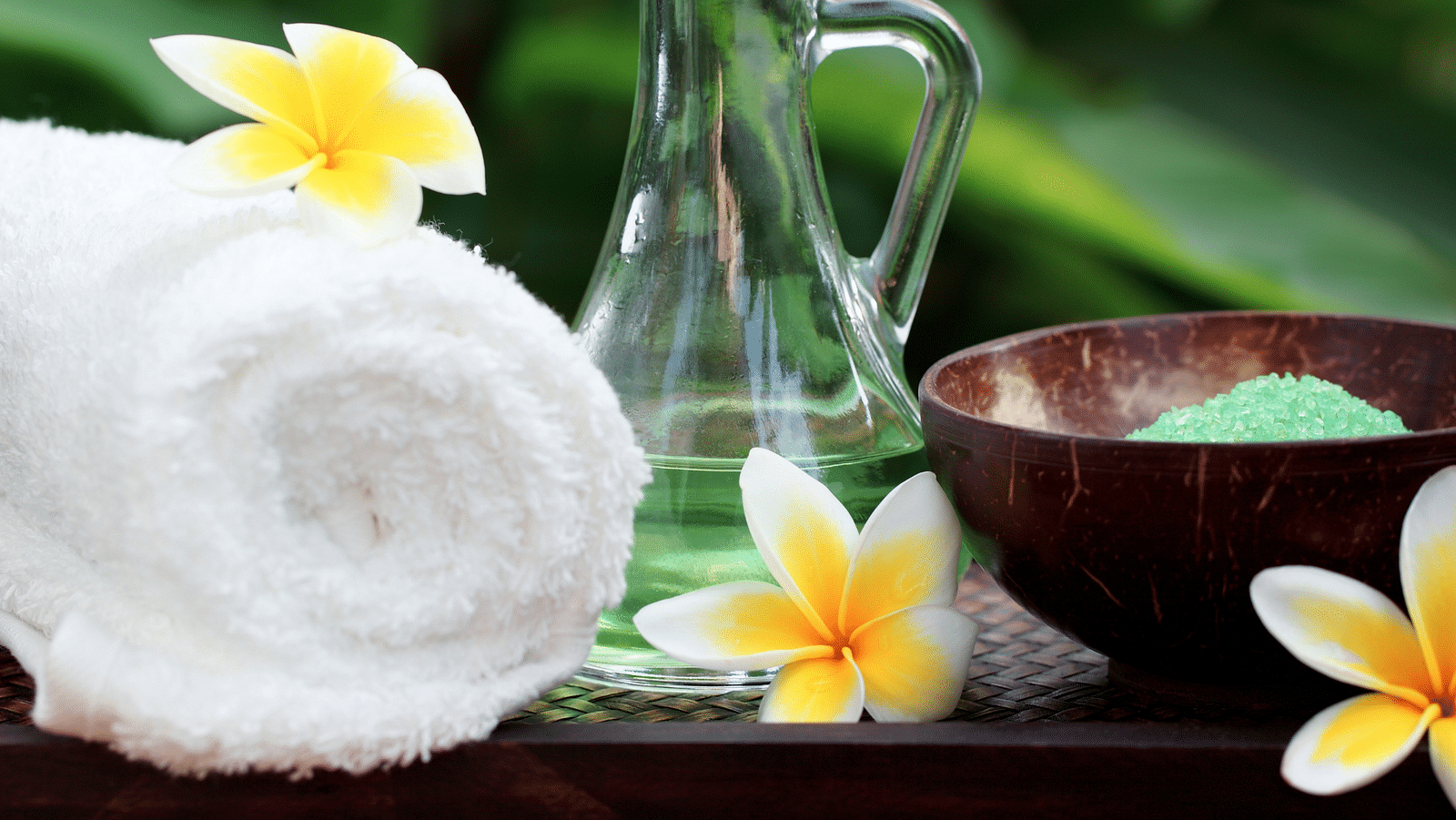 an image of  rolled up towel and a glass jar symbolises wellness - Rhythm Lonavala