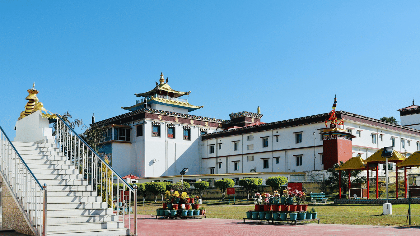 The Mindrolling Monastery with potted plants, steps leading to a building, as seen during day time.
