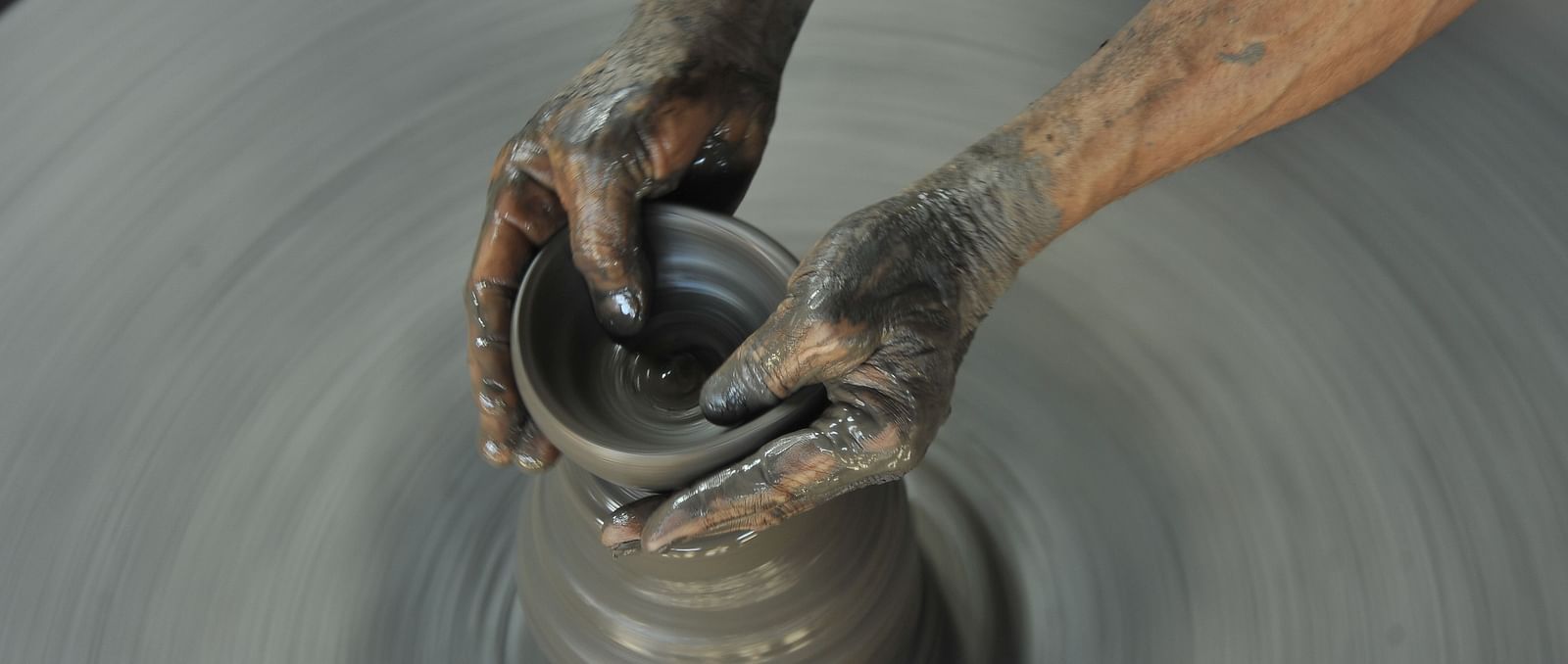 A pair of hands doing pottery