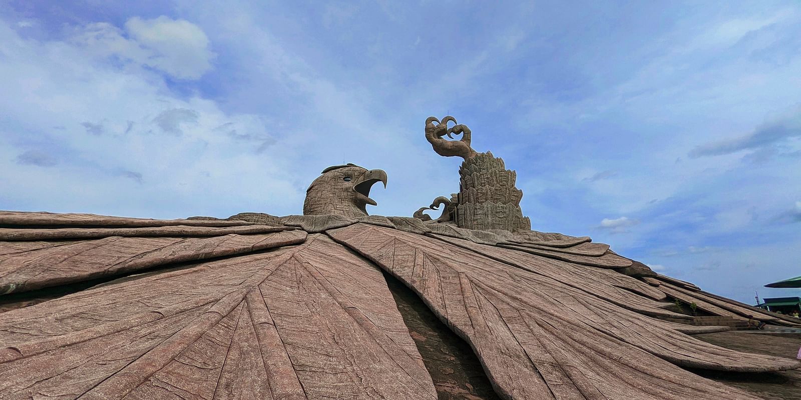 a close up shot of jatayu rock with blue sky in the background