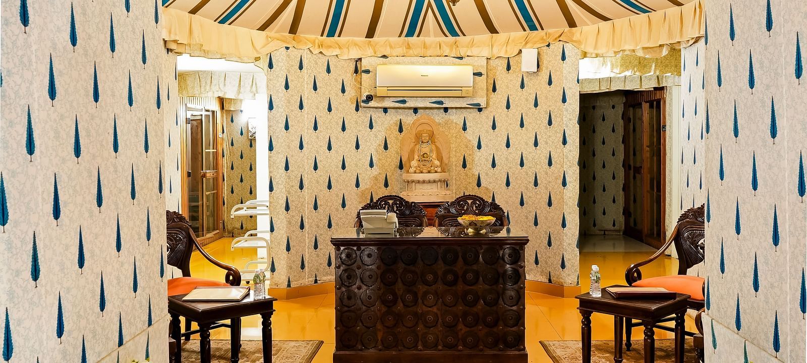 An overview of the reception with a chair and table seen on either side - Rajasthali Resort & Spa, Jaipur.
