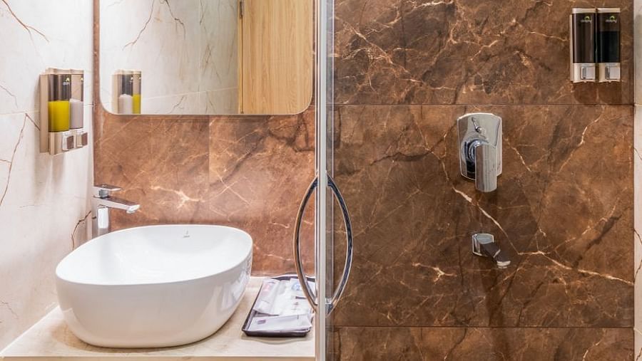 Shower area with modern fittings in The Premium Rooms at Livancia The Sojourn, Bangalore.