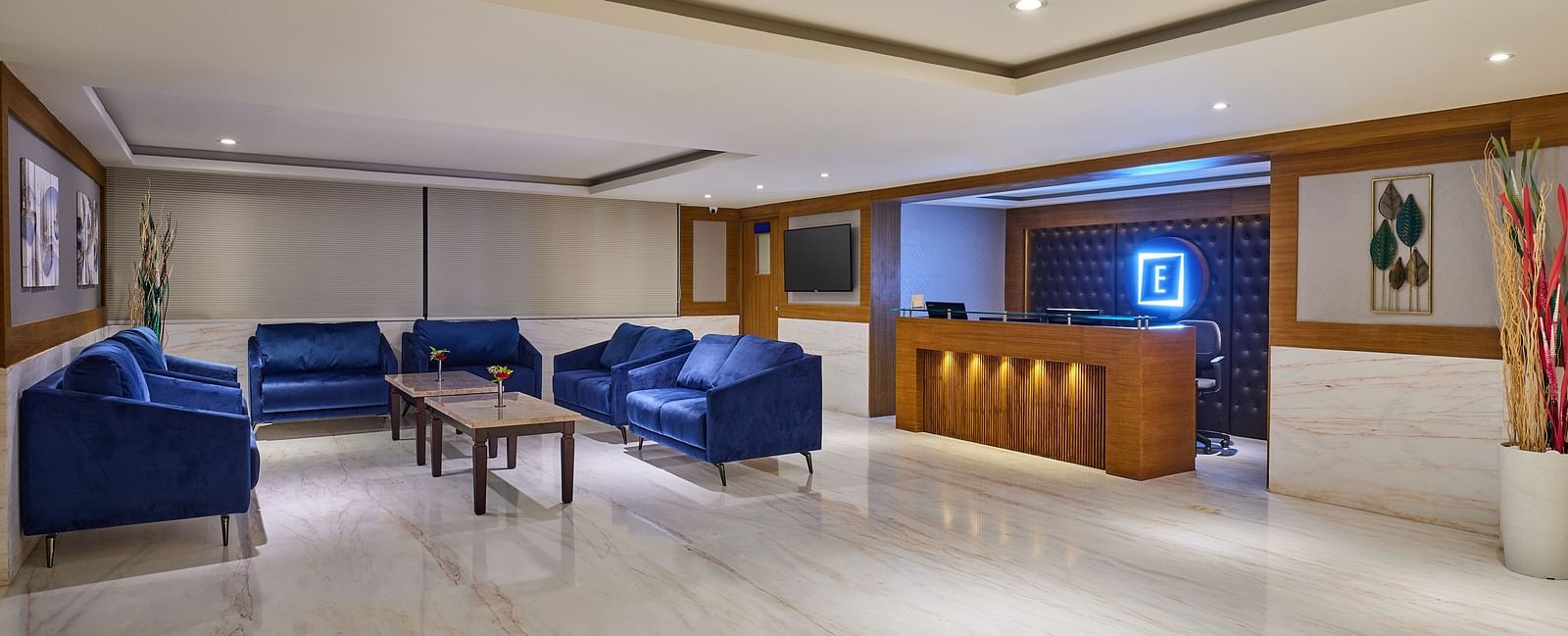 Lobby area of Essentia Premier Hotel, Chennai with sofa seating and a reception desk