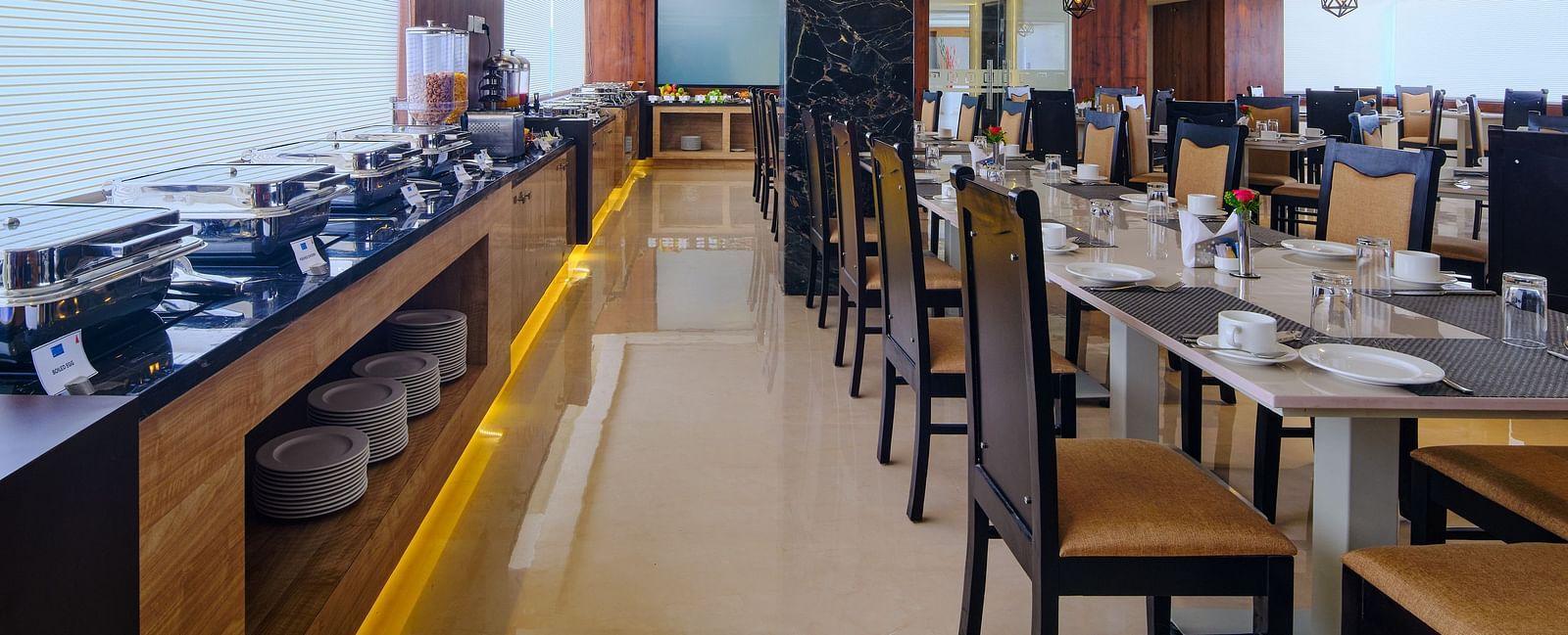 Table arrangement besides the buffet set up at Blue Salt and Coffee at Essentia Premier Hotel, Chennai