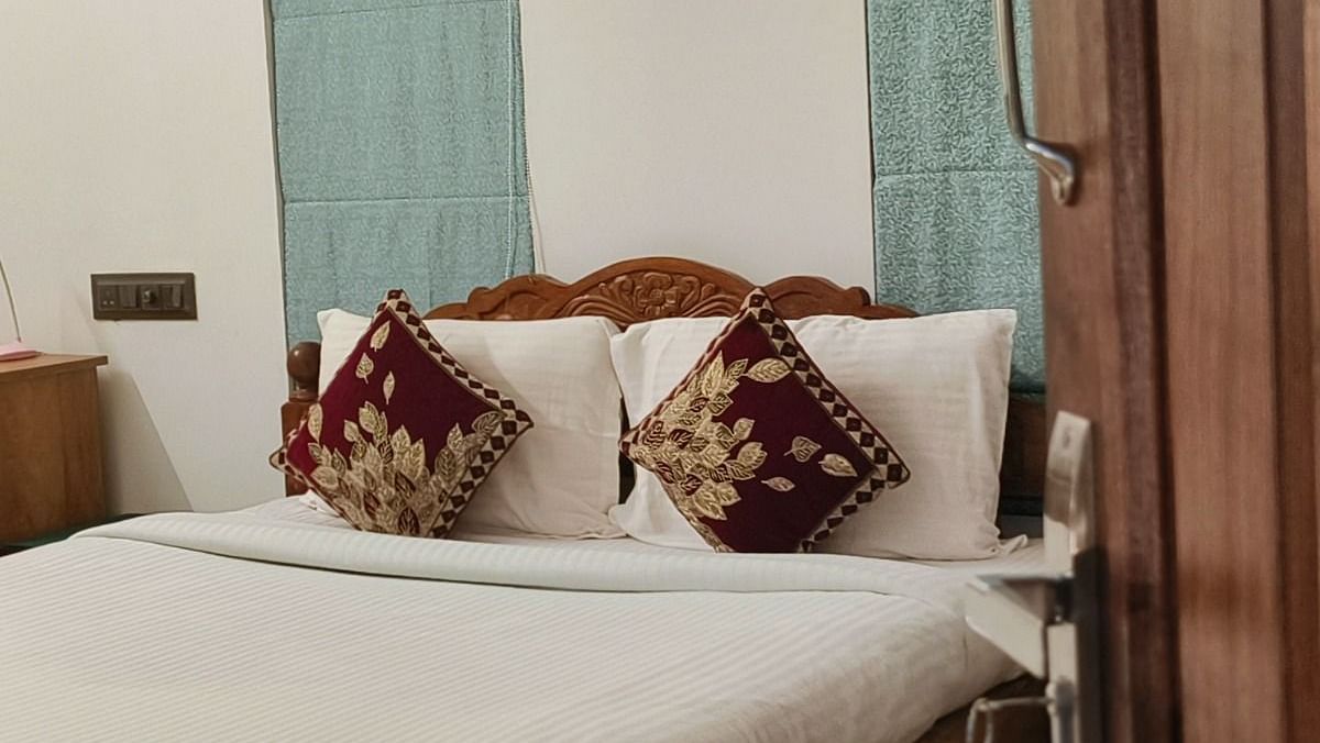 View of a double bed from the door of 104 room at Ananda Holiday Home, Wayanad 1