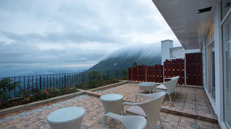 Half cloudy sky and mountain view from the balcony at Fragrant Nature Munnar.