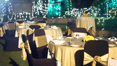 An outdoor space with chairs, tables, and lights set up for an event. | The Bristol Hotel
