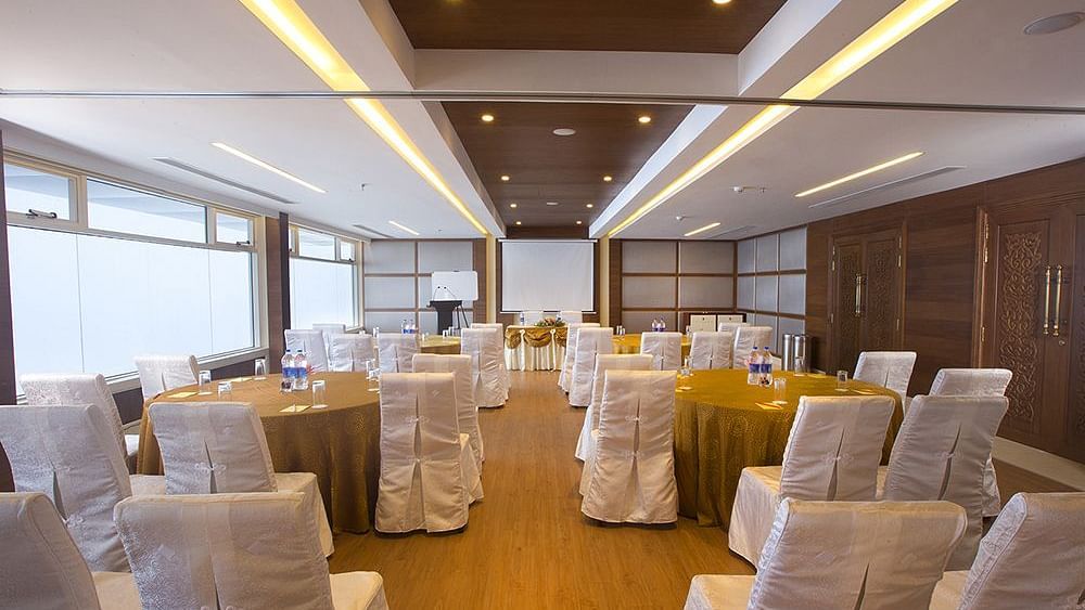  Banquet hall at Fragrant Nature Munnar, elegantly decorated with chairs and celebratory adornments