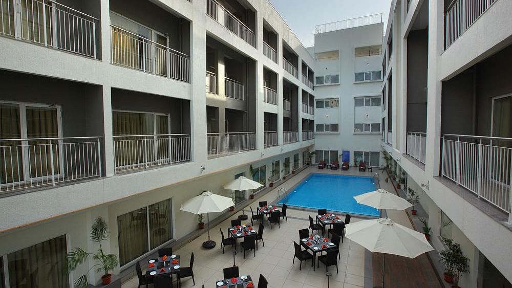 Al fresco seating next to the swimming pool - Starlit Suites, Kochi