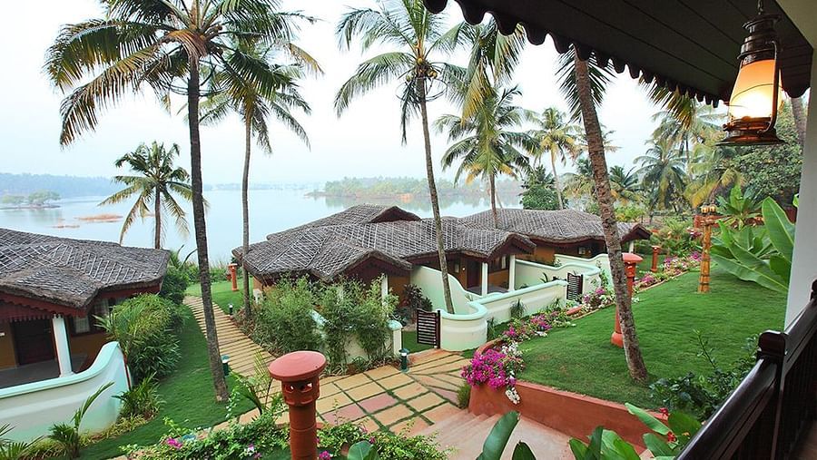 Facade view of the building with coconut trees surrounding the area