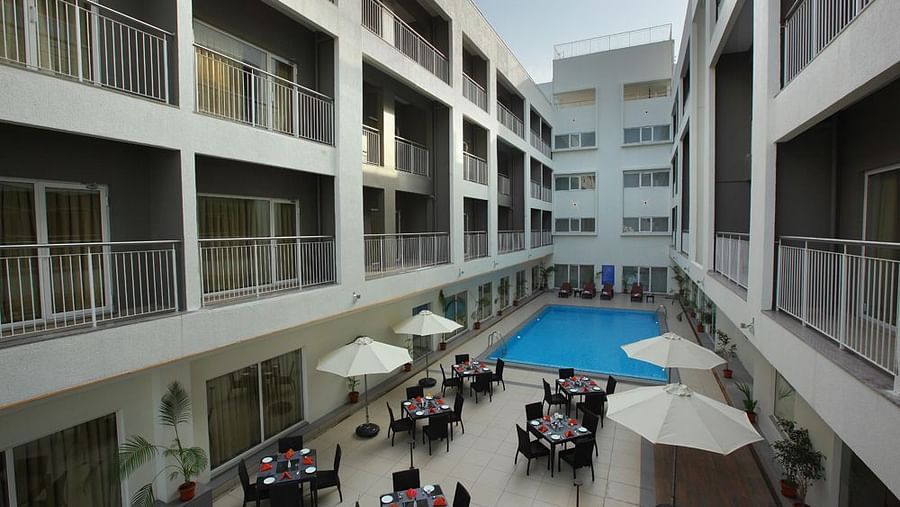 Al fresco seating next to the swimming pool - Starlit Suites, Kochi