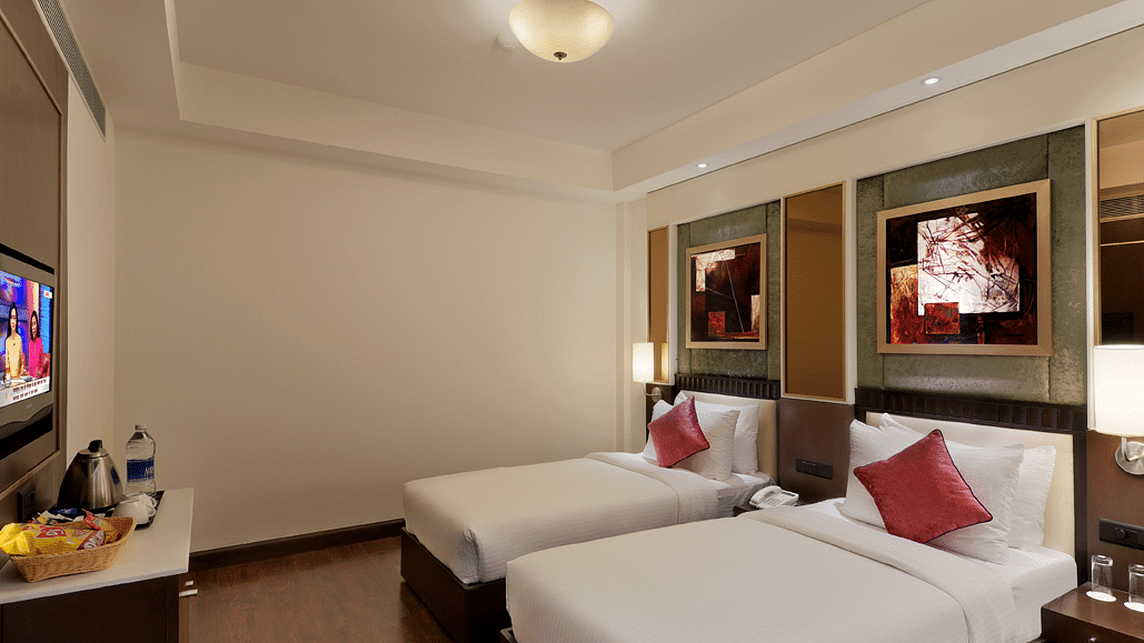 view of twin bed in Premium twin room of Inde Hotel Vista Woods, Gurgaon 