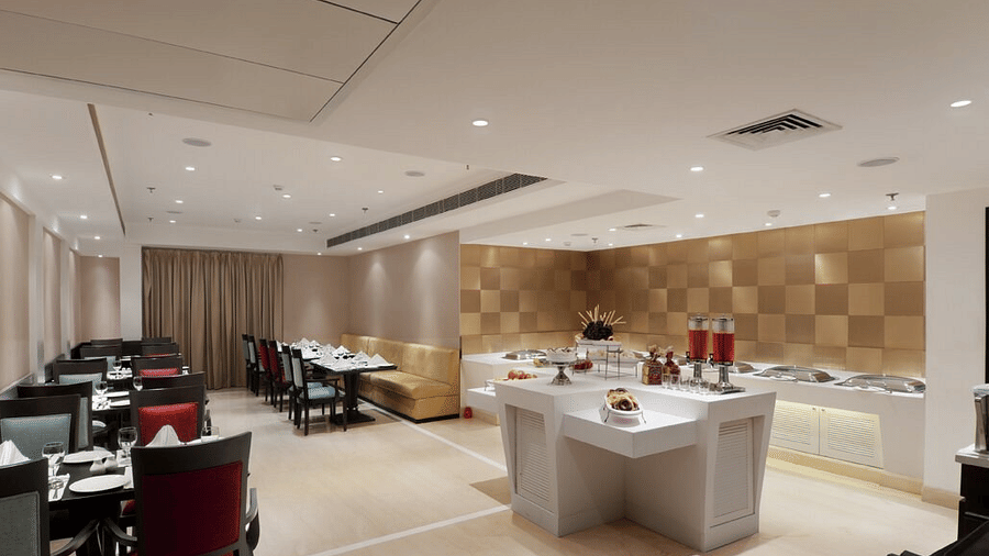 A bright, contemporary dining room at Eastlynn Collections Huda City Centre, Gurugram, is ready for guest service.