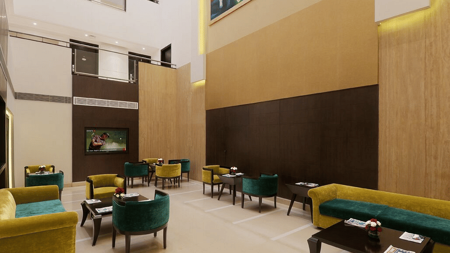Modern velvet seating in green and yellow fills the spacious lobby at Eastlynn Collections Huda City Centre, Gurugram.